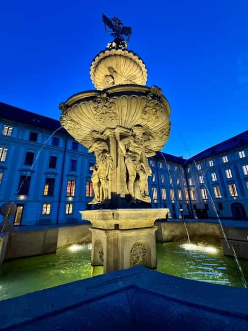 Prague: Night Walk through Prague Castle with City Views - Rudolf II’s palace courtyard and the glow inside the windows
